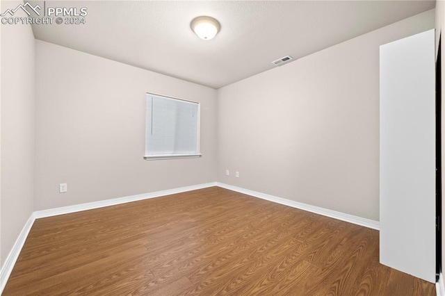 spare room featuring wood-type flooring