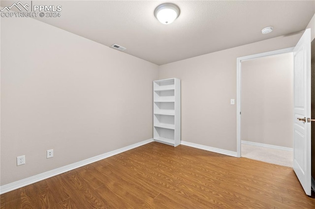 unfurnished bedroom featuring hardwood / wood-style flooring