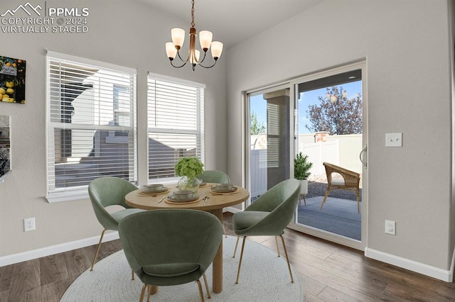 dining area featuring dark hardwood / wood-style flooring and a chandelier