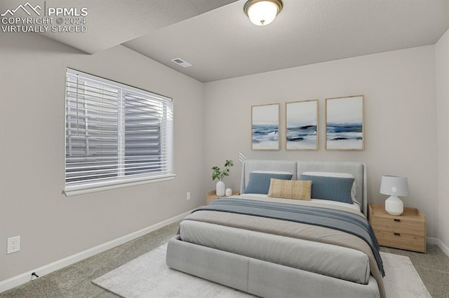 bedroom featuring light colored carpet