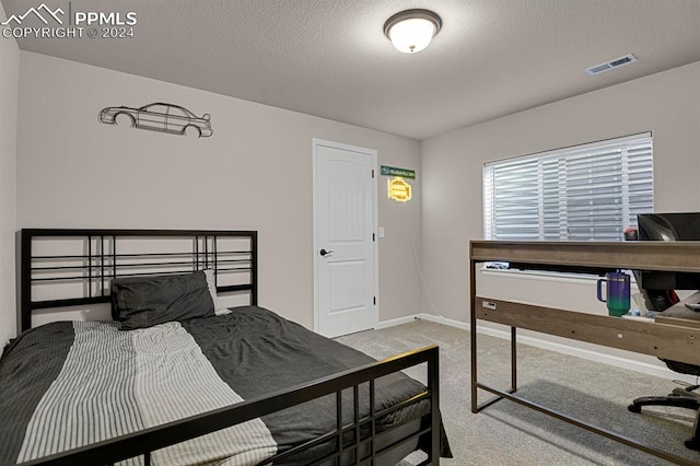 carpeted bedroom with a textured ceiling