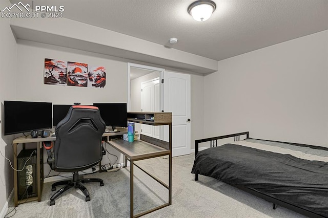 carpeted bedroom featuring a textured ceiling