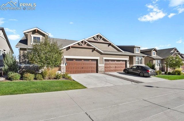 craftsman-style house featuring a garage and a front lawn