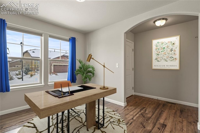 home office with dark hardwood / wood-style floors