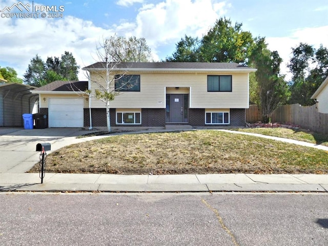 bi-level home featuring a front yard and a garage