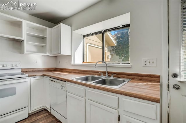 kitchen with white cabinets, butcher block counters, sink, and white appliances