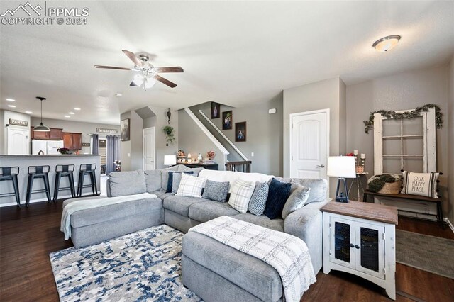 living area featuring recessed lighting, dark wood-style flooring, ceiling fan, and stairs