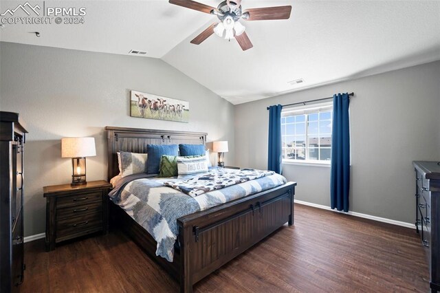 bedroom featuring lofted ceiling, dark wood-style flooring, visible vents, and baseboards