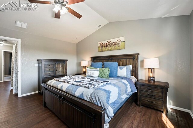 bedroom with lofted ceiling, dark wood-style flooring, visible vents, and baseboards