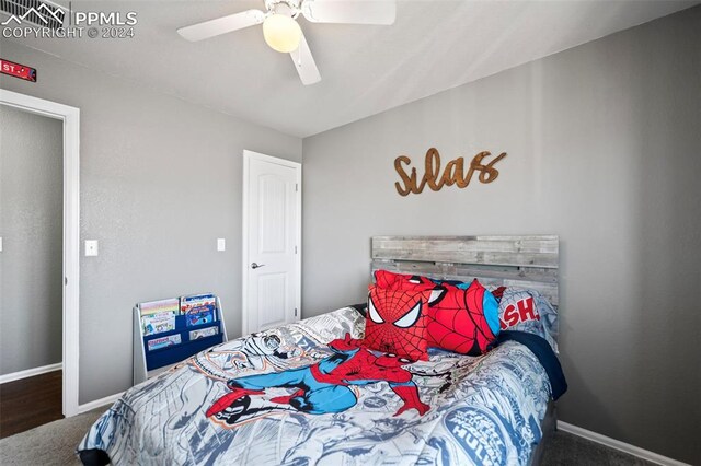 carpeted bedroom featuring baseboards and a ceiling fan