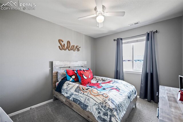 carpeted bedroom featuring ceiling fan, visible vents, and baseboards