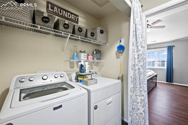 clothes washing area with laundry area, baseboards, washer and clothes dryer, a ceiling fan, and wood finished floors