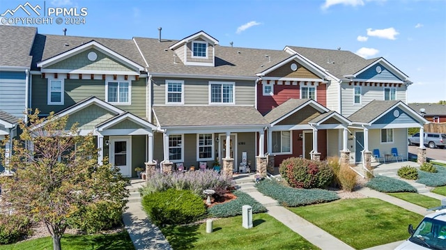 view of property with a shingled roof, a residential view, and a porch