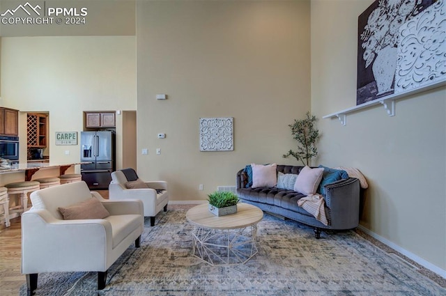 living room featuring a towering ceiling