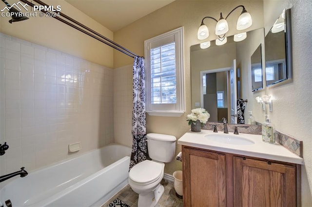 full bathroom featuring toilet, vanity, and shower / bath combination with curtain