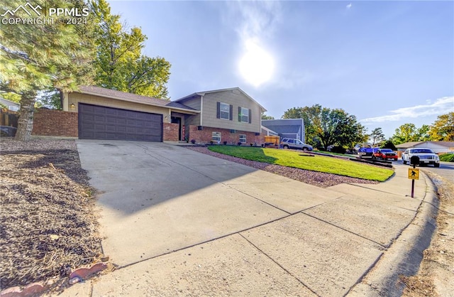 view of front of property with a garage and a front lawn