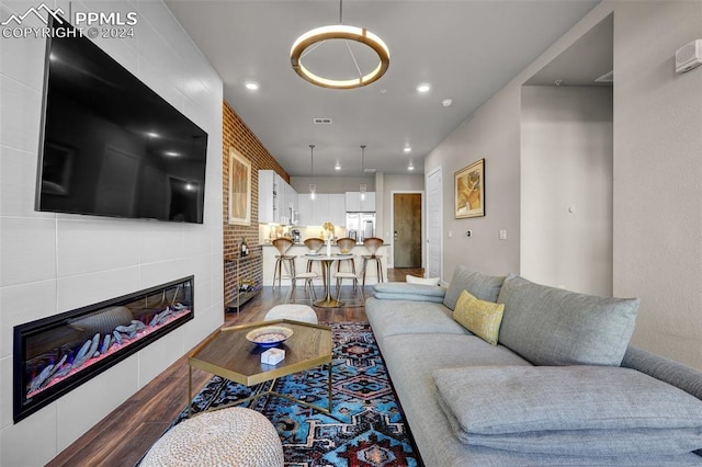 living area featuring visible vents, recessed lighting, wood finished floors, and a fireplace
