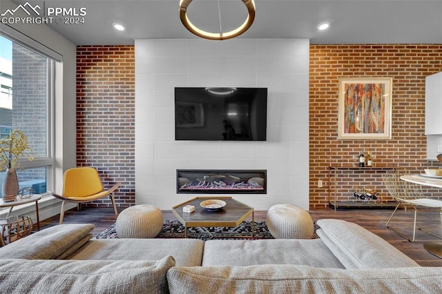living room featuring recessed lighting, wood finished floors, and a tile fireplace
