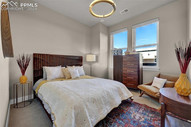 bedroom with carpet, visible vents, and baseboards
