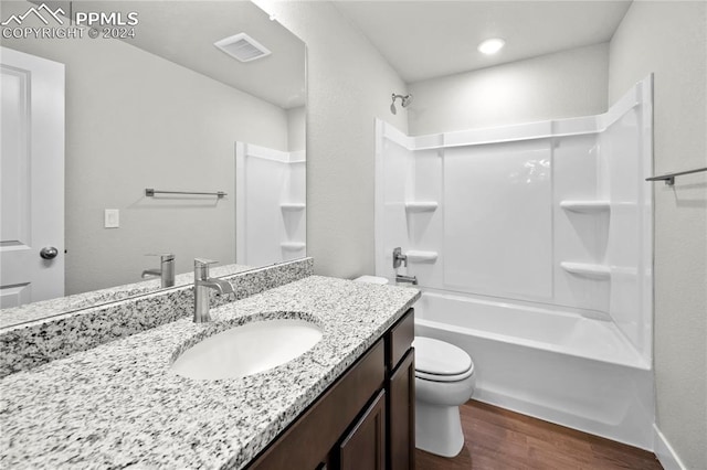 full bathroom featuring shower / tub combination, hardwood / wood-style flooring, vanity, and toilet