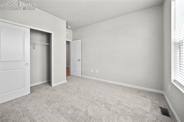 unfurnished bedroom with a closet and carpet