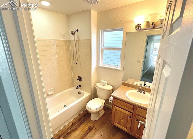 full bathroom with vanity, washtub / shower combination, toilet, and wood-type flooring