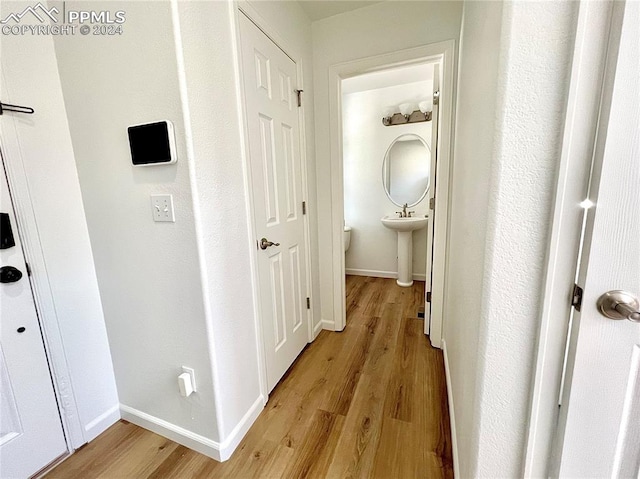 corridor with light wood-type flooring