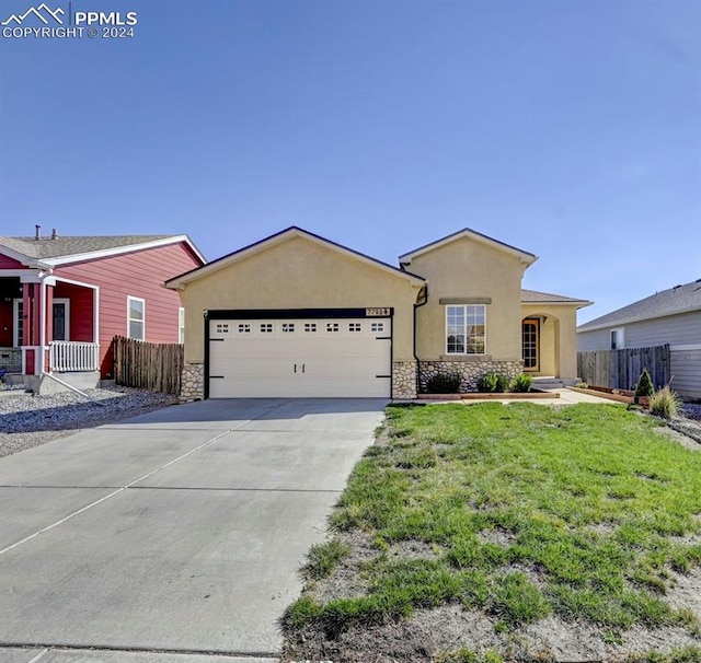 ranch-style home featuring a front yard and a garage