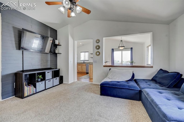 living room featuring lofted ceiling, carpet floors, and ceiling fan