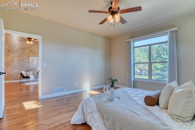 bedroom featuring light wood-type flooring and ceiling fan