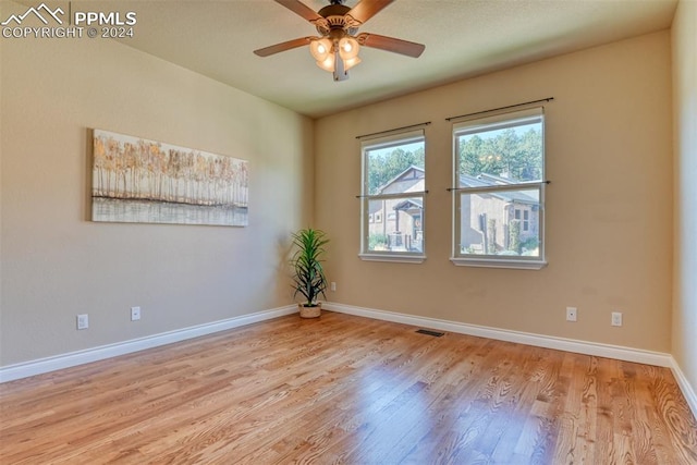 spare room with light hardwood / wood-style floors and ceiling fan