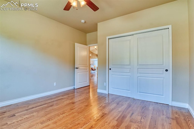 unfurnished bedroom with a closet, light hardwood / wood-style floors, and ceiling fan