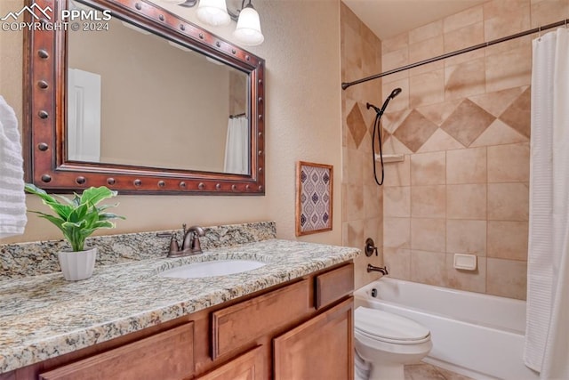 full bathroom with vanity, shower / bath combo, and toilet