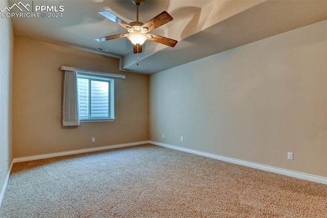 carpeted spare room with ceiling fan