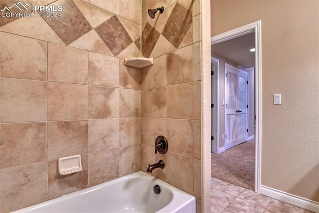 bathroom featuring tiled shower / bath combo and tile patterned floors