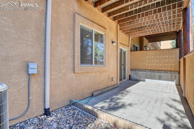 view of property exterior with a patio area