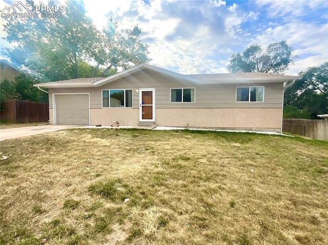 view of front of property featuring a garage and a front lawn