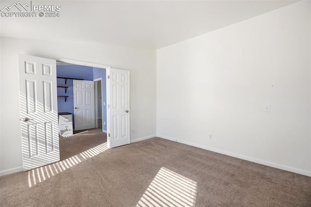 spare room with carpet flooring and baseboards