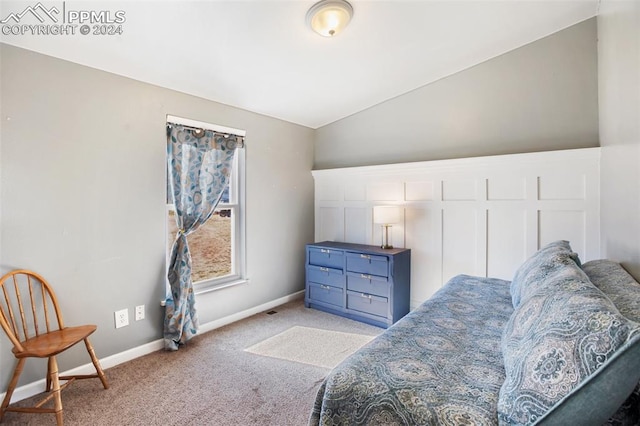 living area with baseboards, light colored carpet, and lofted ceiling