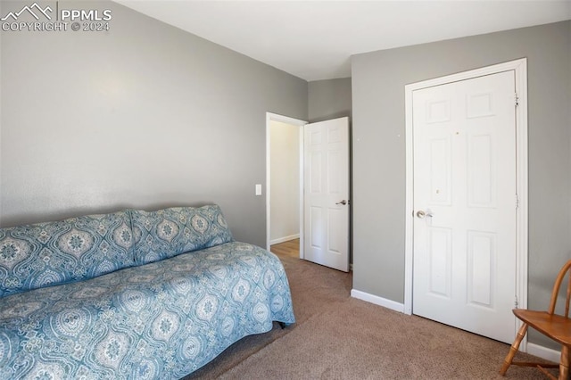 carpeted bedroom featuring baseboards