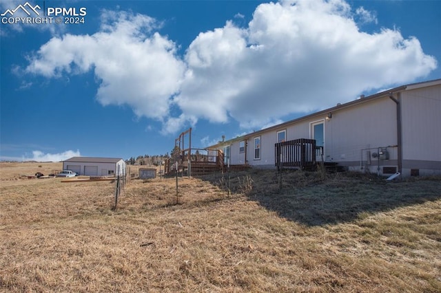 view of yard with a wooden deck