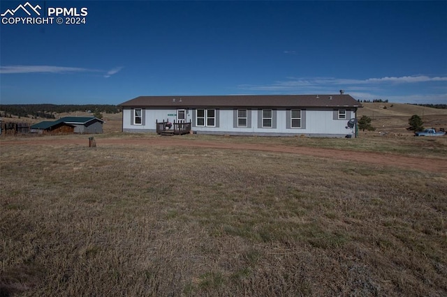 back of property featuring a lawn