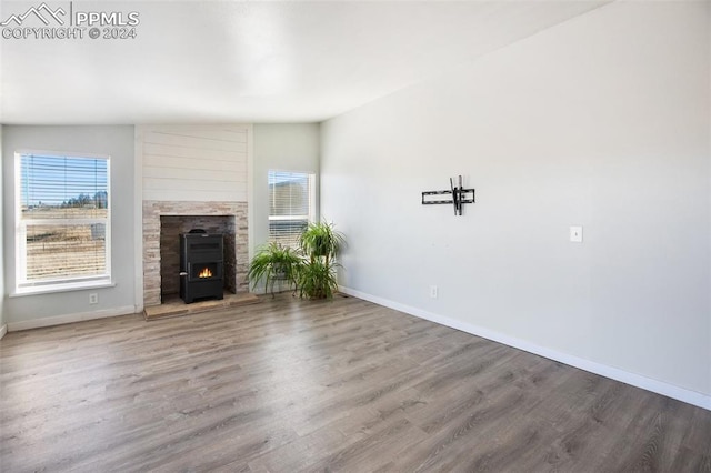 unfurnished living room featuring baseboards and wood finished floors