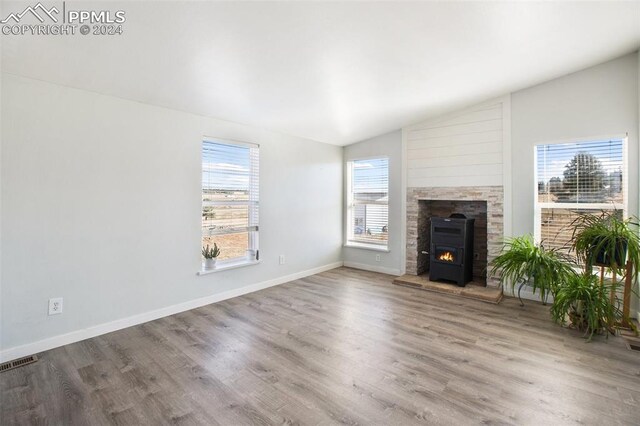 unfurnished living room featuring lofted ceiling, wood finished floors, and visible vents