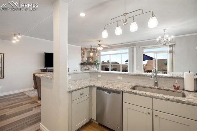 kitchen featuring wood-type flooring, light stone counters, sink, ornamental molding, and stainless steel dishwasher