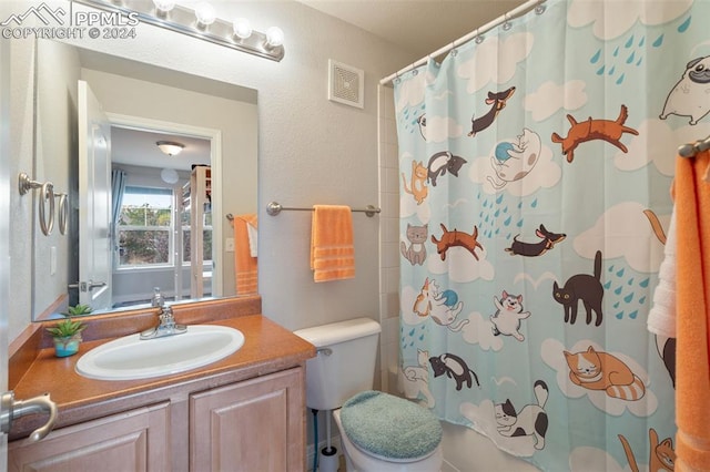 bathroom with vanity, walk in shower, and toilet