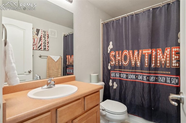 bathroom with vanity, toilet, and curtained shower