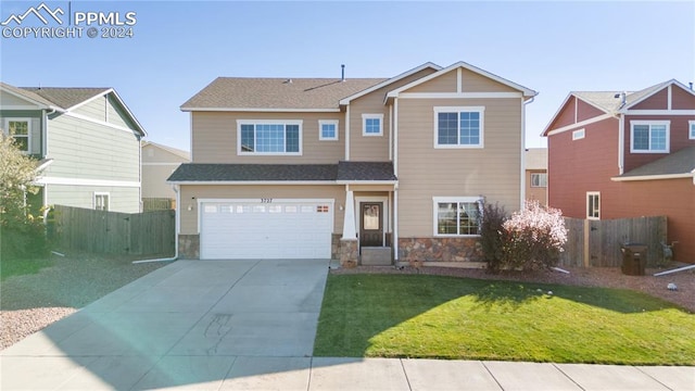 view of front of home featuring a front lawn and a garage