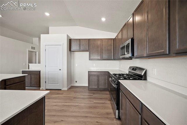 kitchen featuring dark brown cabinetry, visible vents, appliances with stainless steel finishes, light countertops, and light wood-type flooring