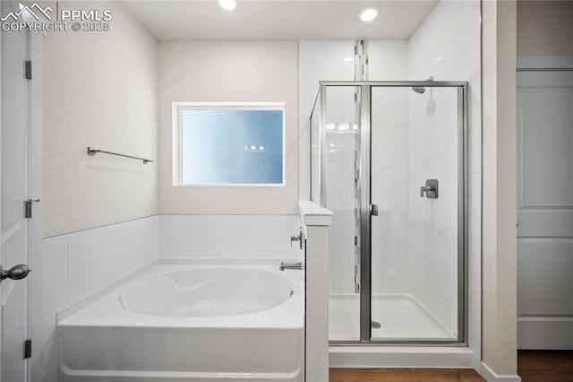 full bath featuring a garden tub, recessed lighting, wood finished floors, and a stall shower